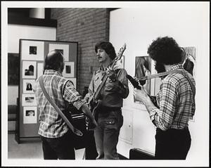 Guitar performance before an audience in the GCC art gallery