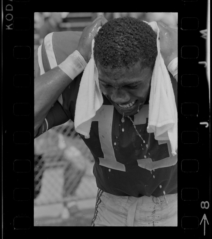 R. C. Gamble, Pats' standout sophomore running back, douses himself with a sopping wet towel to counteract 90 degree temperatures which prevailed during club's intra-squad scrimmage