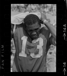 R. C. Gamble, Pats' standout sophomore running back, douses himself with a sopping wet towel to counteract 90 degree temperatures which prevailed during club's intra-squad scrimmage