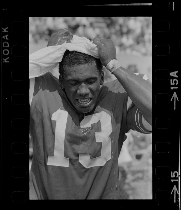 R. C. Gamble, Pats' standout sophomore running back, douses himself with a sopping wet towel to counteract 90 degree temperatures which prevailed during club's intra-squad scrimmage