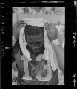 R. C. Gamble, Pats' standout sophomore running back, douses himself with a sopping wet towel to counteract 90 degree temperatures which prevailed during club's intra-squad scrimmage