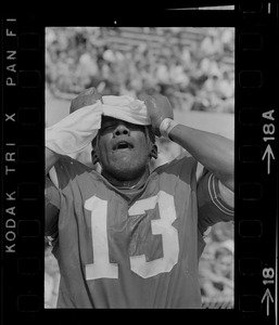 R. C. Gamble, Pats' standout sophomore running back, douses himself with a sopping wet towel to counteract 90 degree temperatures which prevailed during club's intra-squad scrimmage