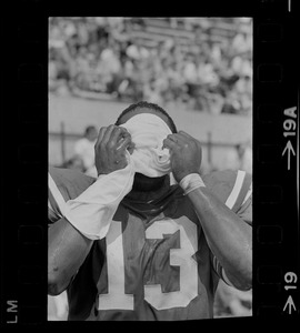 R. C. Gamble, Pats' standout sophomore running back, douses himself with a sopping wet towel to counteract 90 degree temperatures which prevailed during club's intra-squad scrimmage