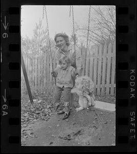 Maggie Bellotti, wife of Francis X. Bellotti, playing with child