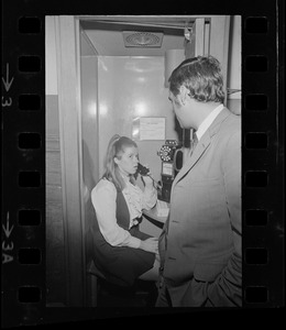 Susan Brennan on payphone at Suffolk County Courthouse after being charged with contempt
