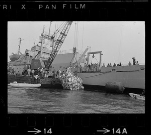 Web of supports holds $1.5 million research submarine Alvin as it is lifted from water at Menemsha Bight before being placed on barge