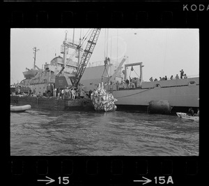 Web of supports holds $1.5 million research submarine Alvin as it is lifted from water at Menemsha Bight before being placed on barge