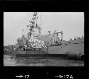 Web of supports holds $1.5 million research submarine Alvin as it is lifted from water at Menemsha Bight before being placed on barge