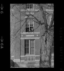 Student sitting in window at Amherst College during building occupation