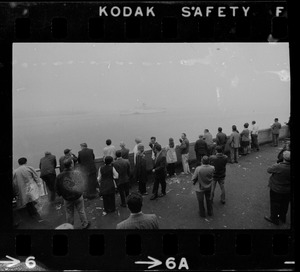 SS Amerikanis slices out of fog as worried kin of passengers wait