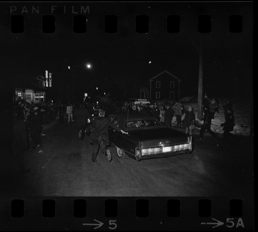 Car of United States President Richard Nixon and Pat Nixon drives past anti-war demonstration after visiting daughter Julie's apartment in Northampton