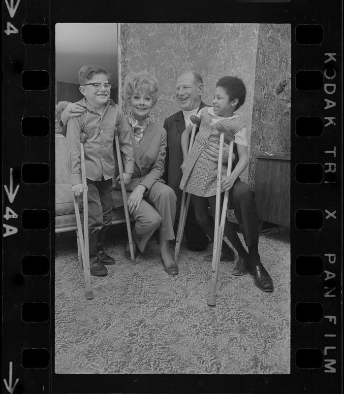 National Easter Seal sponsor Lucille Ball and Mass. Chairman for the drive, Suffolk Downs Pres. Bill Veeck, entertain two Easter Seal youngsters Jeff A. Smith, 10, of Easton, and Valerie Fleetwood, 8, of Roxbury, as state-wide fund campaign begins to help society aid crippled children