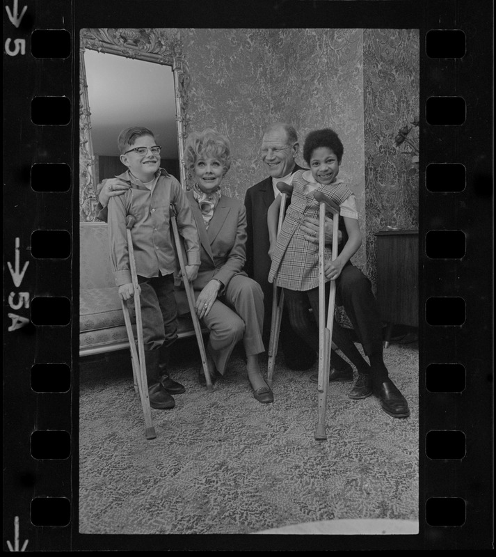 National Easter Seal sponsor Lucille Ball and Mass. Chairman for the drive, Suffolk Downs Pres. Bill Veeck, entertain two Easter Seal youngsters Jeff A. Smith, 10, of Easton, and Valerie Fleetwood, 8, of Roxbury, as state-wide fund campaign begins to help society aid crippled children