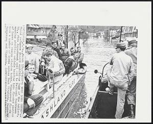 There's More Down There'-- Flood refugees aboard amphibious DUKW of the Ashland, Ky., fire department call out to National Guardsmen manning similar vehicle heading into flooded section of Logan on rescue mission today. Widespread floods took a number of lives across West Virginia, Kentucky, Tennessee and Virginia.