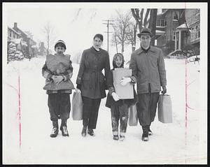 Carrying The Feed-Bags - Mr. and Mrs. Edward McCarthy of 5 Marcia Rd., Watertown; their son, Edward Jr., 12, and daughter, Jacqueline, 9, above, put aside their car yesterday and walked to their market. "It's nice; sort of old-fashioned," McCarthy told a reporter.