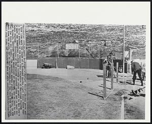 Finley’s ‘Pennant Porch’--Wooden posts and a tape line mark the shape of a V-shaped wooden right field fence that is being erected by the Kansas City Athletics at Municipal Stadium to make the boundaries conform as closely as rules permit to New York’s Yankee Stadium. Erection of the stadium started today and on hand was Cal Hubbard, American League supervisor of umpires, was on hand to see that the fence was legal. The nearest wooden stake, shown here, is 296 feet from the plate, but in fair territory, just two feet from the right field foul line.