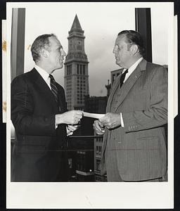 Mayor Kevin H. White (l) accepts a $15,000 check from George C. Seybolt, chairman of the Board of Trustees of Suffolk University. It marks the first payment in lieu of taxes from any of the city's 33 tax-exempt educational institutions.