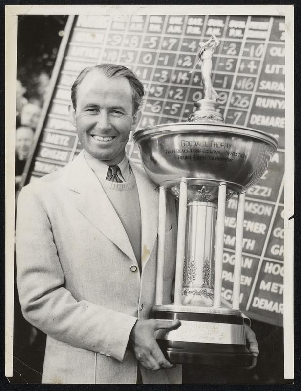 Little Man Wins Big Trophy-Paul Runyan, the giant killer of the pro-golf ranks, holds the Goodall trophy at the Fresh Meadow Club in New York after winning the four-day round robin yesterday with a point score of plus 26-10 points ahead of runners-up.