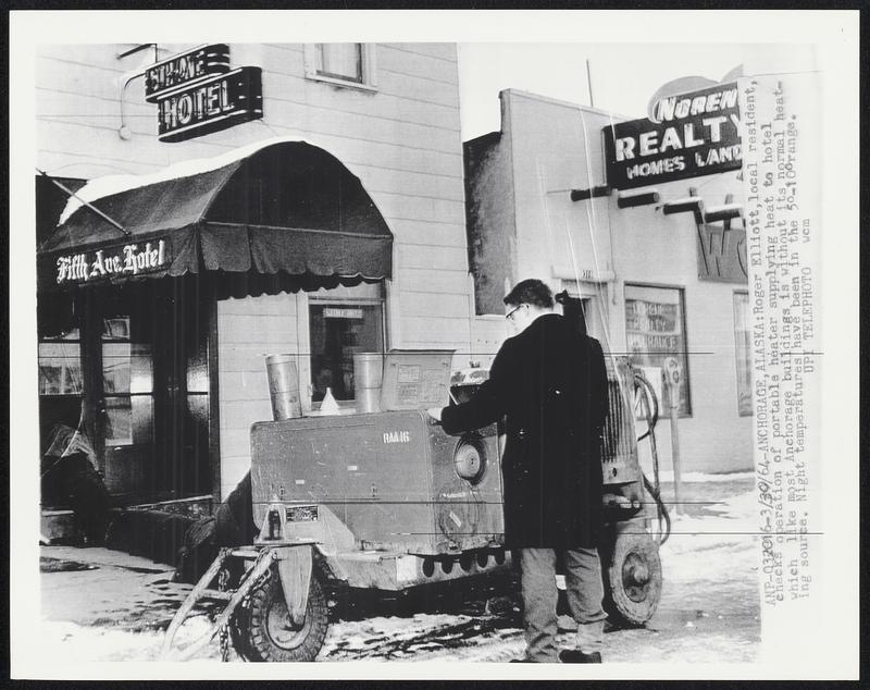 Roger Elliott, local resident, checks operation of portable heater supplying heat to hotel which like most Anchorage buildings is without its normal heating source. Night temperatures have been in the 5å¡-10å¡ range.