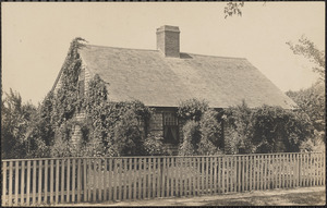 Photo of house almost covered with ivy