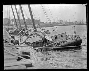 Submerged boats by a pier