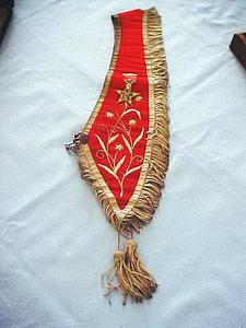 Red and gold sash with fringe