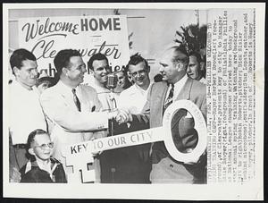 Phillies Welcomed to Spring Training Camp -- Mayor Herbert Brown (left foreground), of Clearwater, presents key to city to Manager Eddie Sawyer (right, foreground) of Philadelphia Phillies as National League champions arrived here today to start annual spring training. Watching are (background left to right) Robin Roberts, pitcher; Dick Sisler (behind microphone), outfielder; Stan Lopata, catcher, and Russ Meyer, pitcher. In front of Roberts is Henry the Phillies tiny bat boy.