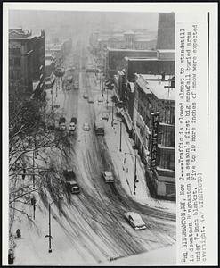 Traffic is slowed almost to standstill in downtown Binghamton as season's first big snowfall buried are under 7-inch blanket. Five to 10 more inches of snow were expected overnight.