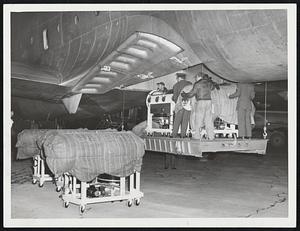 Iron Lungs for Argentina were loaded into a U.S. Air Force Globemaster yesterday for delivery to Buenos Aires, where a polio epidemic has spread at a rate of 40 cases daily. Two Boston firms furnished 21 machines for the government's goodwill mission.