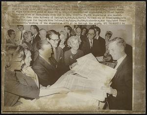 Mass. Secy. of State Kevin White (R) and his staff have a long night's work ahead, as Gov. John Volpe and Lt. Gov. Elliot Richardson (2nd, L) hand sheet of signatures from pile of some 90 to 100,000 uncertified signatures, in first hurdle to reduce size of Mass. House from 240 to 160, (12/7). 70,204 signatures are needed. Shown LTR; Mrs. John W. Drake of Lexington, Mrs. M. H. Martin Wittenborg of Framingham, both of the Citizens for Legislative Reform. Gov. Volpe, Lt. Gov. Richardson, and Rep. Janet Starr (R. Belmont). Counting of the signatures will go on through the night.