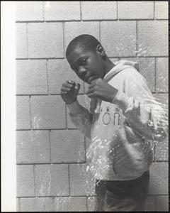 Young man posing with fists raised