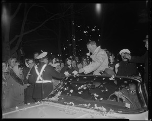 A small size ticker-tape reception welcomes Henry Cabot Lodge and his wife Emily as they enter driveway of their Beverly home
