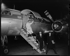 Henry Cabot Lodge. Jr. walking off airplane at Beverly airport, with two other men