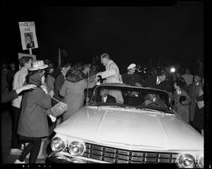 Henry Cabot Lodge, Jr. greeting supporters from the car, with his wife Emily