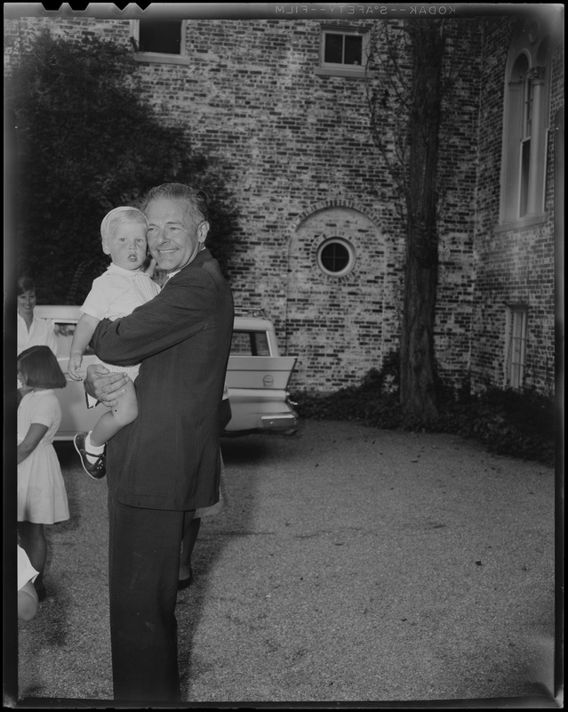 Henry Cabot Lodge, Jr. holding grandson outside his Beverly home