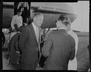Henry Cabot Lodge, Jr. talking with two men in front of an airplane