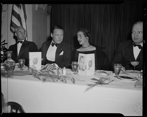 Henry Cabot Lodge, Jr., a woman, and Harold Stassen seated during the Middlesex Club's Lincoln dinner at the Statler Hotel
