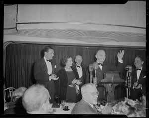Harold Stassen waving as Henry Cabot Lodge, Jr. and others applaud during the Middlesex Club's Lincoln dinner at the Statler Hotel
