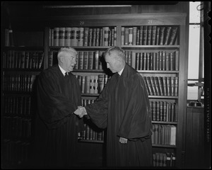 Raymond S. Wilkins, newly appointed Supreme Court Justice, to fill vacancy left by retirement of Stanley Qua, shakes hands with R. Ammi Cutter, newly appointed justice to fill Wilkins' place