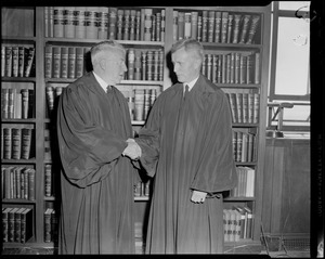 Raymond S. Wilkins, newly appointed Supreme Court Justice, to fill vacancy left by retirement of Stanley Qua, shakes hands with R. Ammi Cutter, newly appointed justice to fill Wilkins' place