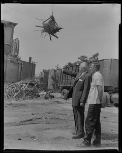 Stanley Blinstrub, South Boston nite club owner, along with foreman John Maher, watch construction of new 1200 car parking lot underway