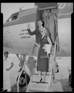 Jack Webb and his wife Dorothy Towne Webb waving from stairs of airplane marked "United Jack Webb Special"