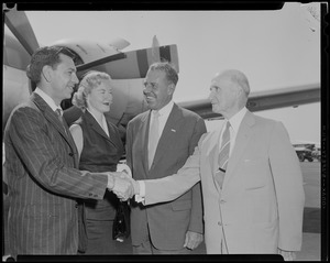 Jack Webb shaking hands with Boston Police Commissioner Thomas F. Sullivan, with wife Dorothy Towne Webb and city greeter Jack Brown in front of airplane