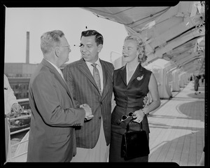 Jack Webb shaking hands with Boston Mayor John B. Hynes, as wife Dorothy Towne Webb looks on
