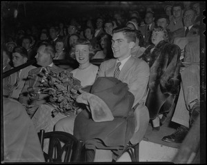 Tenley Albright seated in audience, holding flowers