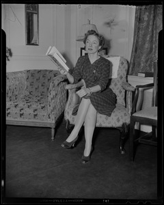 Helen Hayes seated in armchair, holding a book