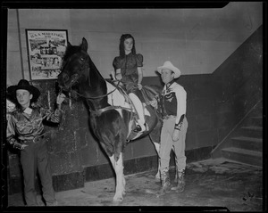 Gene Autry and boy with girl on horse