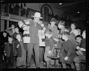 Gene Autry with group of boys at the Salvation Army's South End Boys Club for performance and doughnut dunking contest