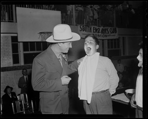 Gene Autry with doughnut dunking competitor at the Salvation Army's South End Boys Club