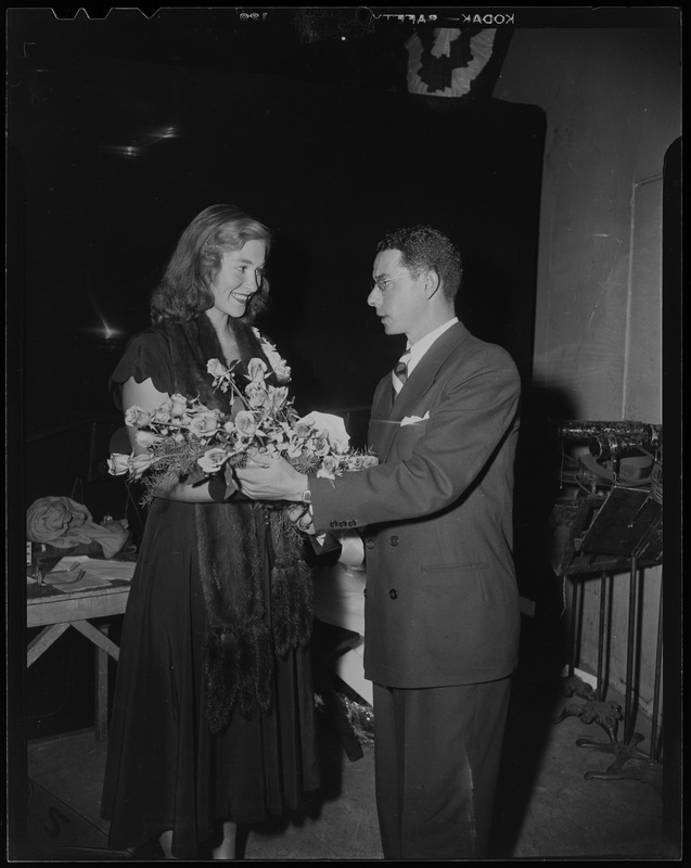 Dom DiMaggio and Shirley May France with bouquet of flowers at benefit for Italian orphanage at Boston Garden